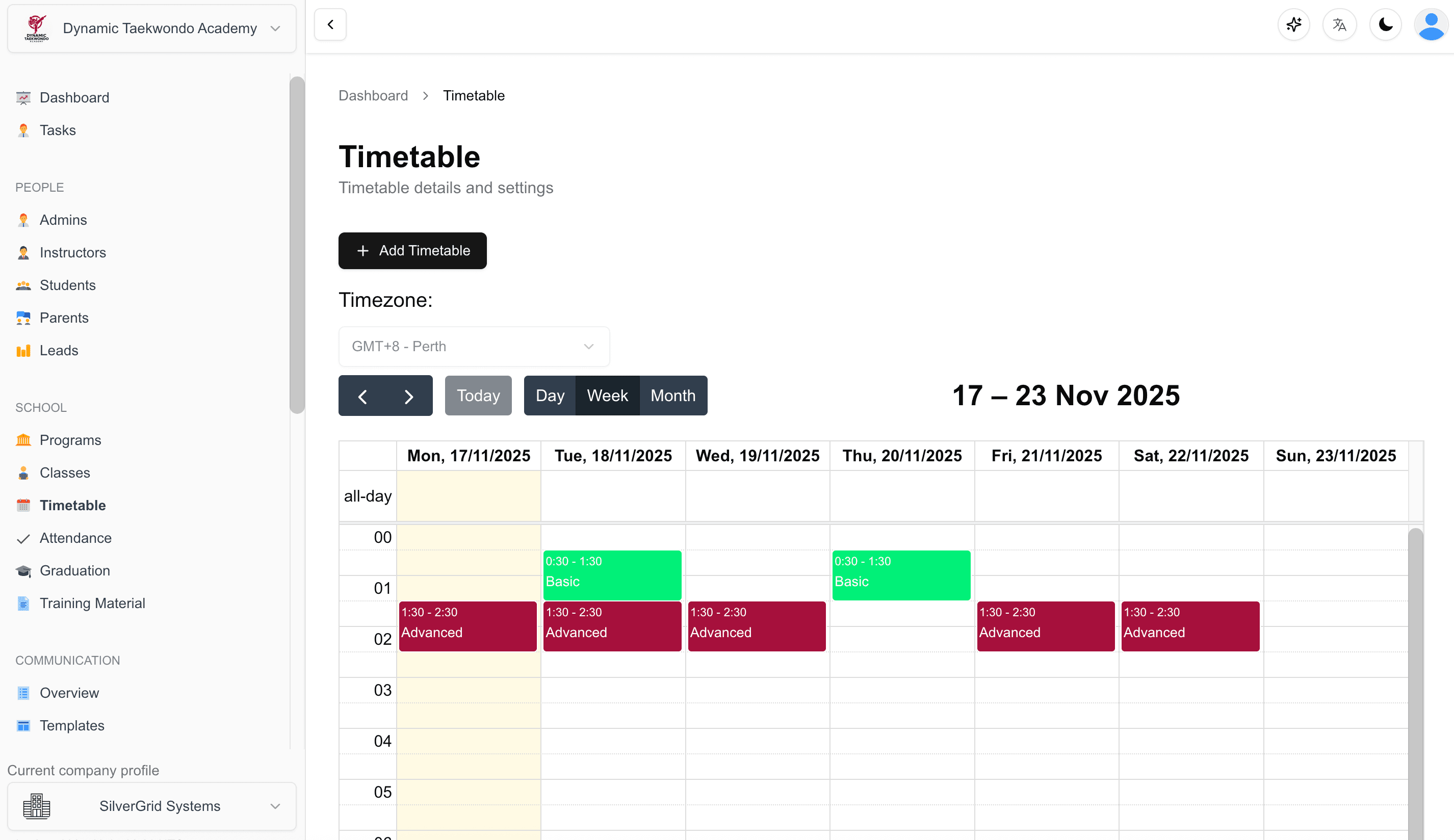 Interactive timetable calendar displaying weekly martial arts class schedule with instructor assignments, time slots, and program details
